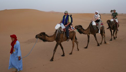 Host Richard Bangs on camelback