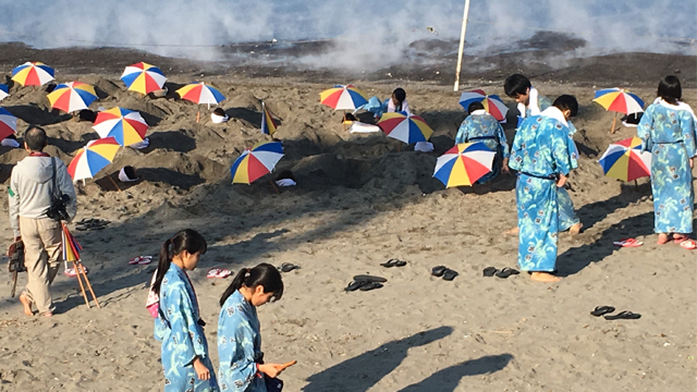 Kuushu residents take advantage of their island's volcanic steam to be buried to the neck in hot sand at the beach.