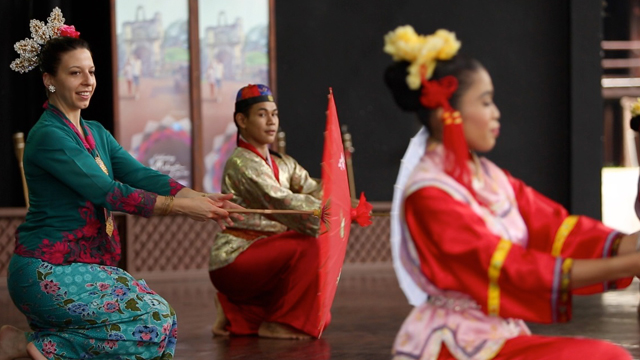 Mickela dances at the mini Malaysia Theme Park in Melaka, Malaysia.