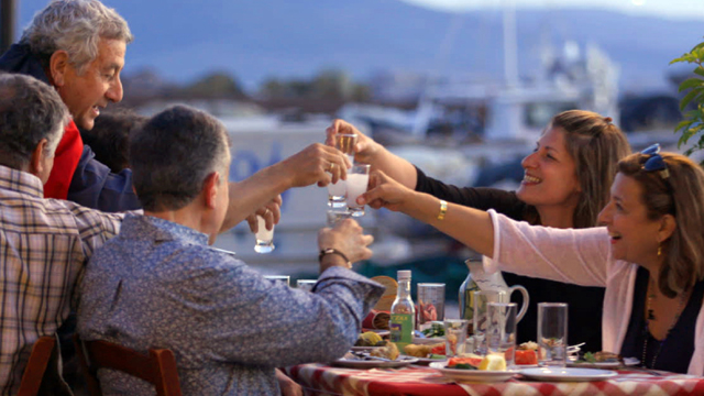 Diane gets an insider’s taste of ouzo with a good friend and local son on the islnad of Lesvos.