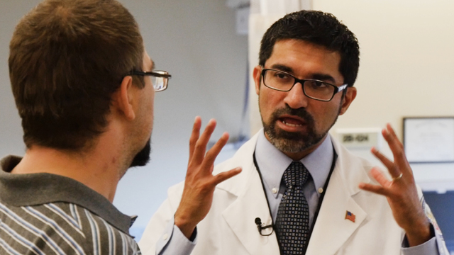 Dr Ajit Pai discusses treatment with U.S. Army Veteran, Scottie Graham.